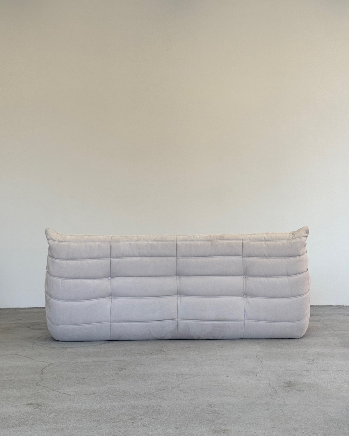 A gray Ligne Roset Togo sofa with a minimalist design 
