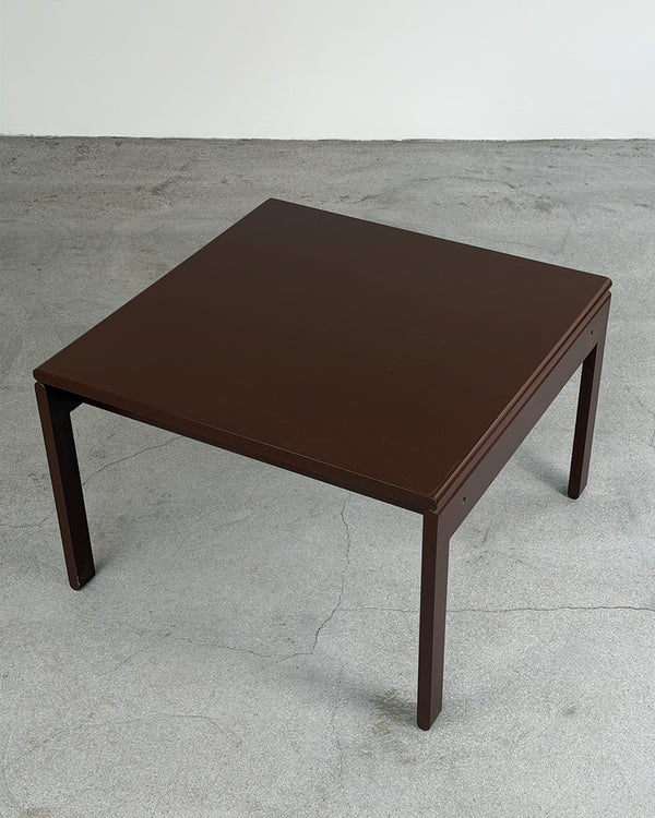 Brown square table on a gray concrete floor