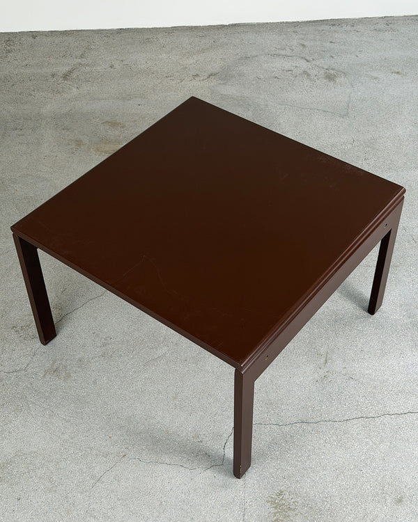 Brown square table on a concrete floor