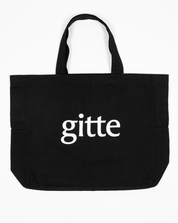 Black tote bag with 'gitte' printed on a white background